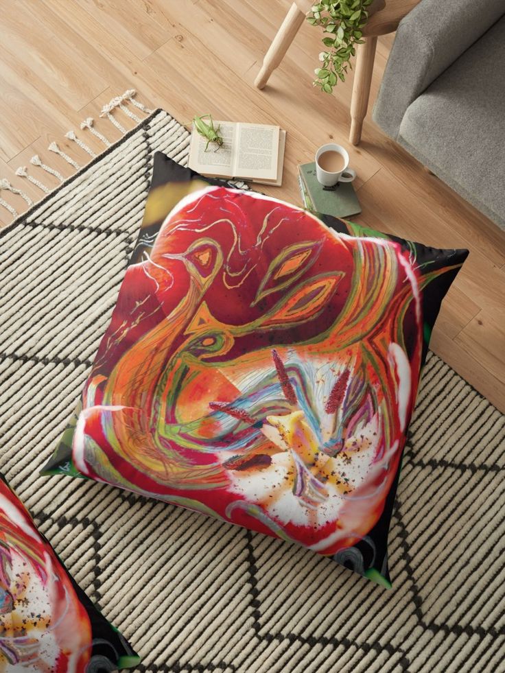 pillow with dominant red abstract art design on floor