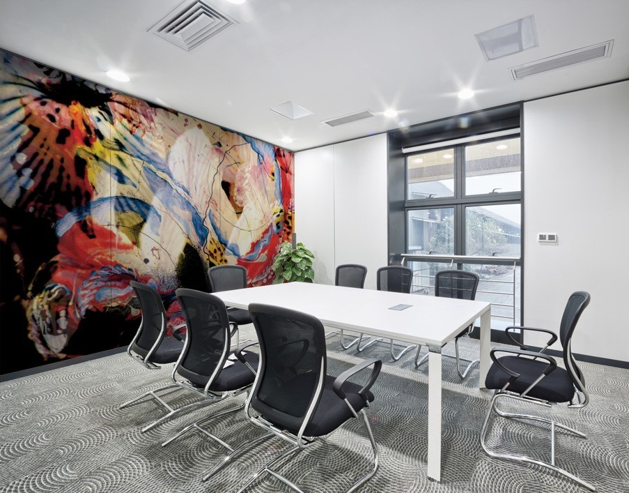 mural decor with abstract dynamic pattern in red, white and black dominant colors on meeting room wall